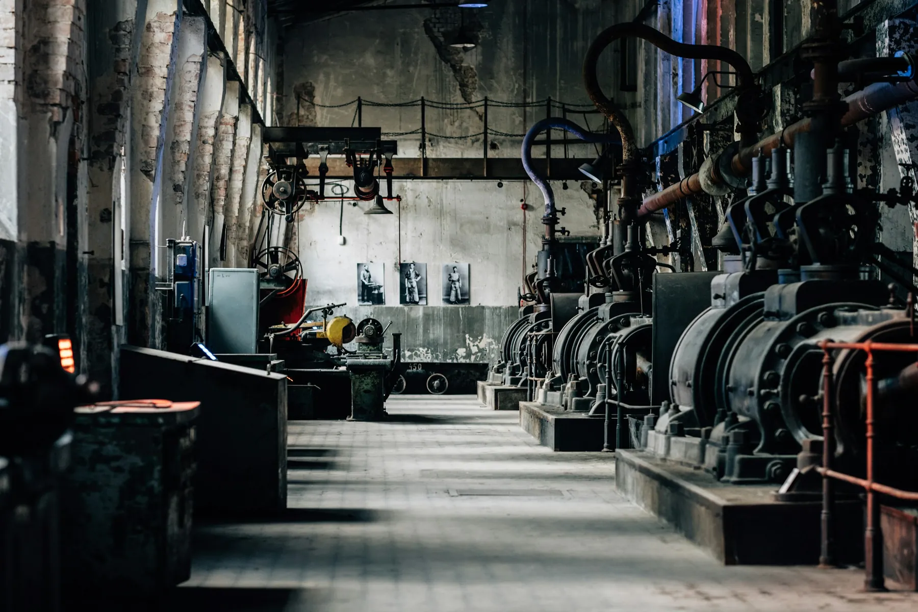 A machine hall, rows of equipment down its length, lit from the windows.